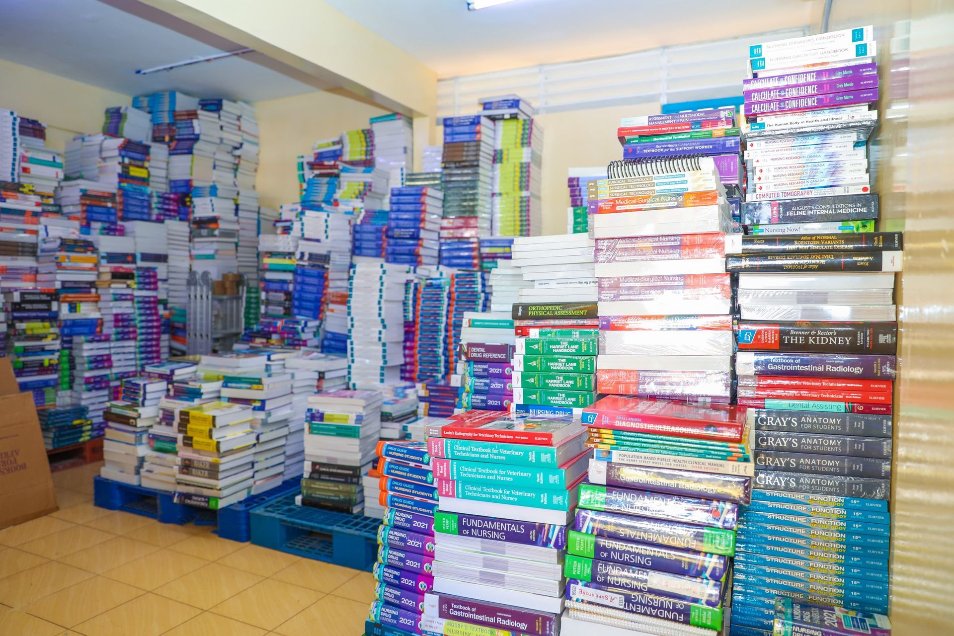 A room filled with lots of books stacked on top of each other.