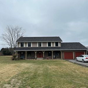 A large house with a car parked in front of it.