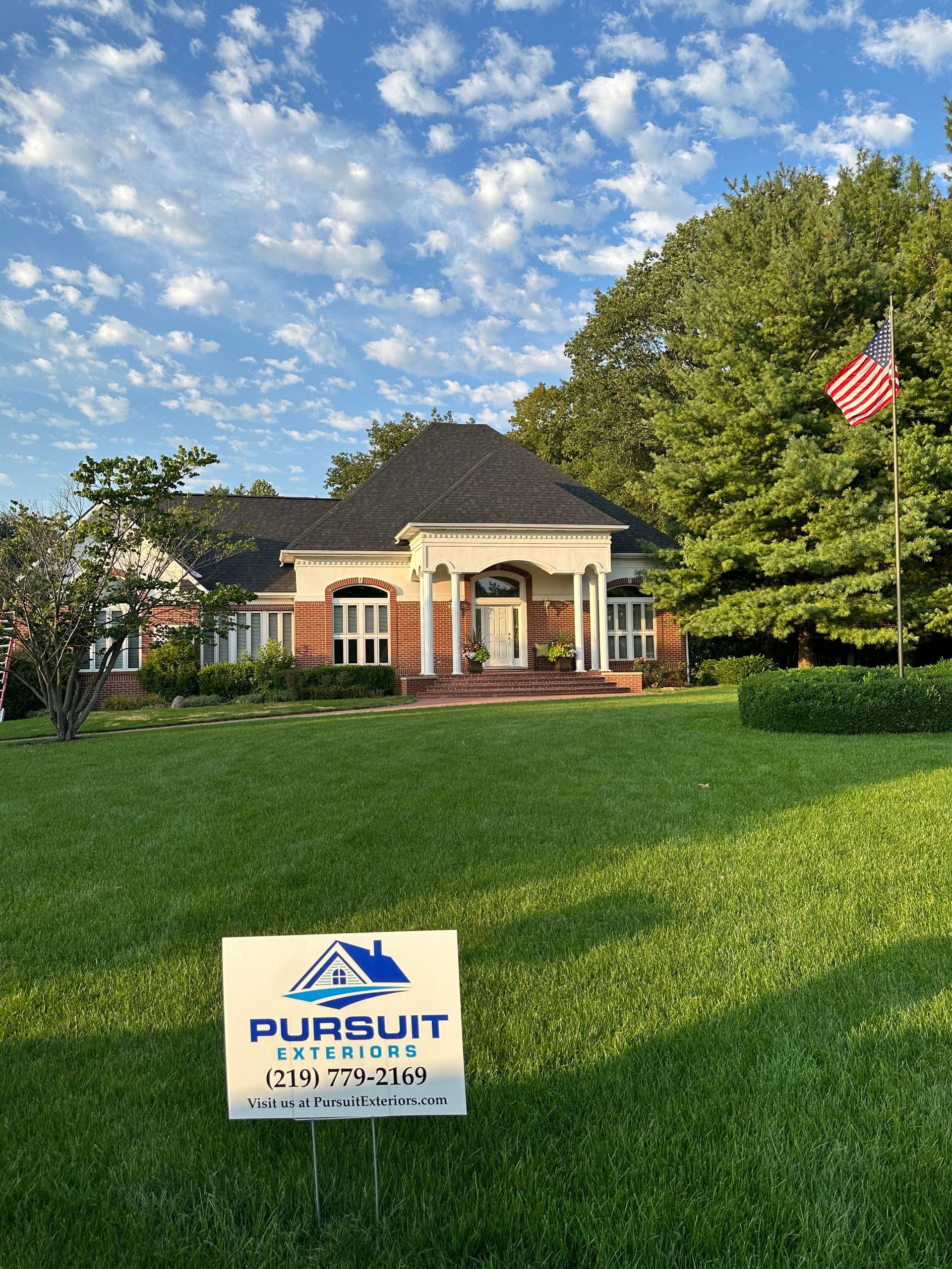 A house with a sign in front of it.