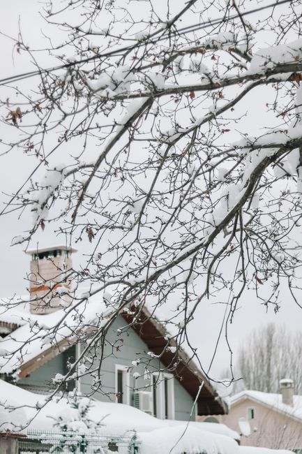 Snow on a house roof in winter