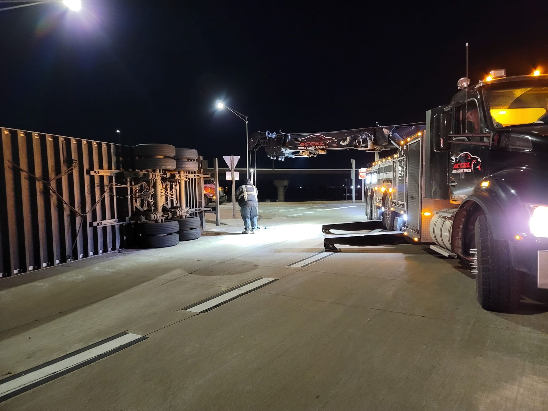 A truck is sitting on the side of the road at night.