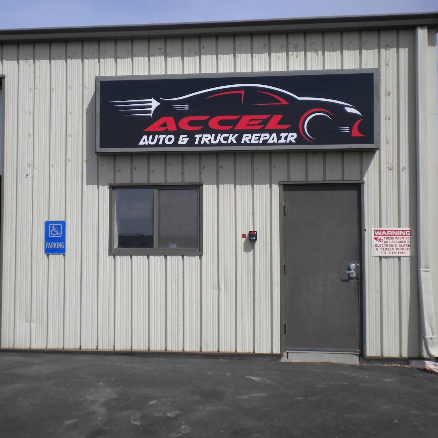 A building with a sign that says accelera auto & truck repair.