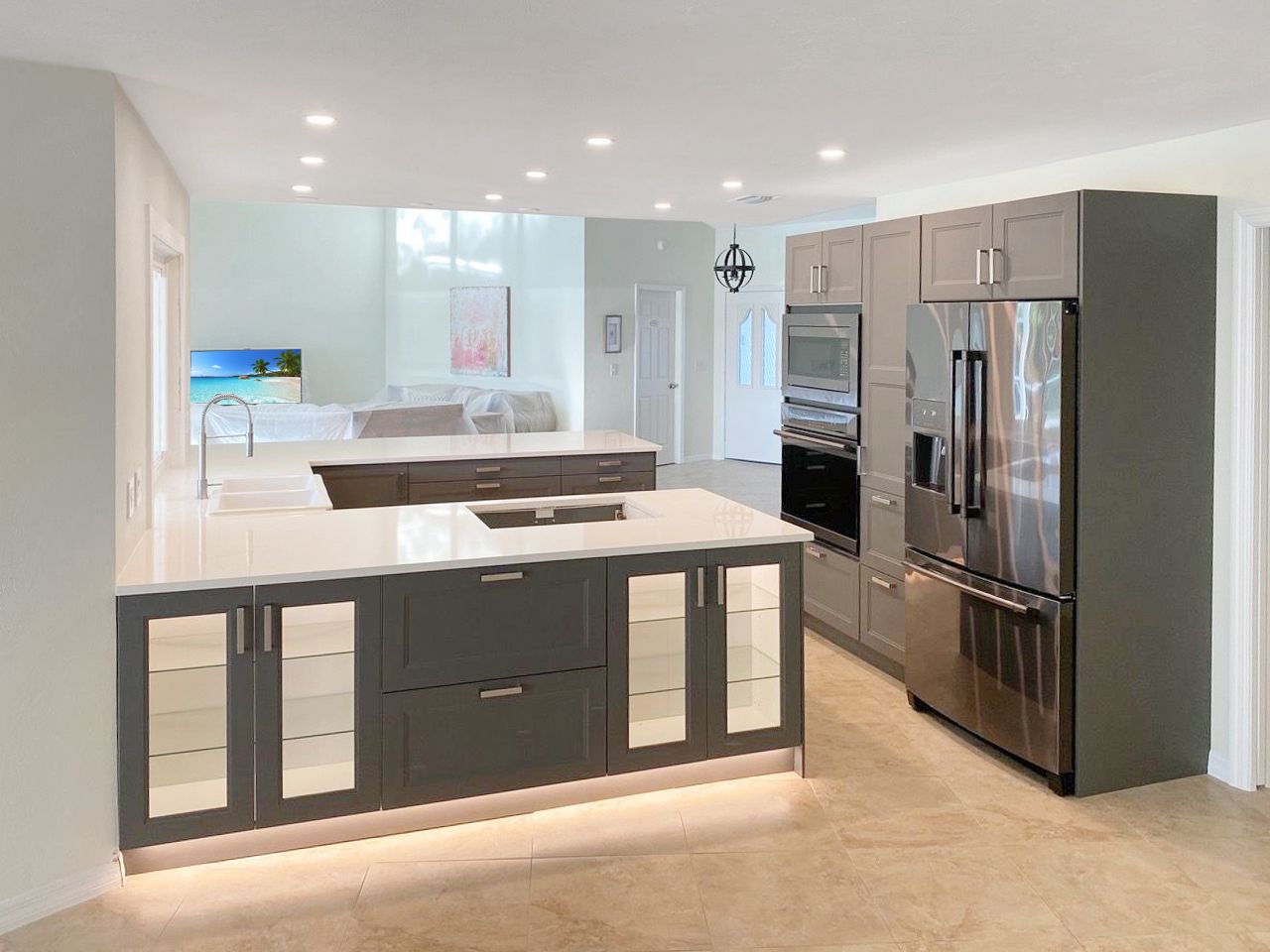 A kitchen with stainless steel appliances and a large island.