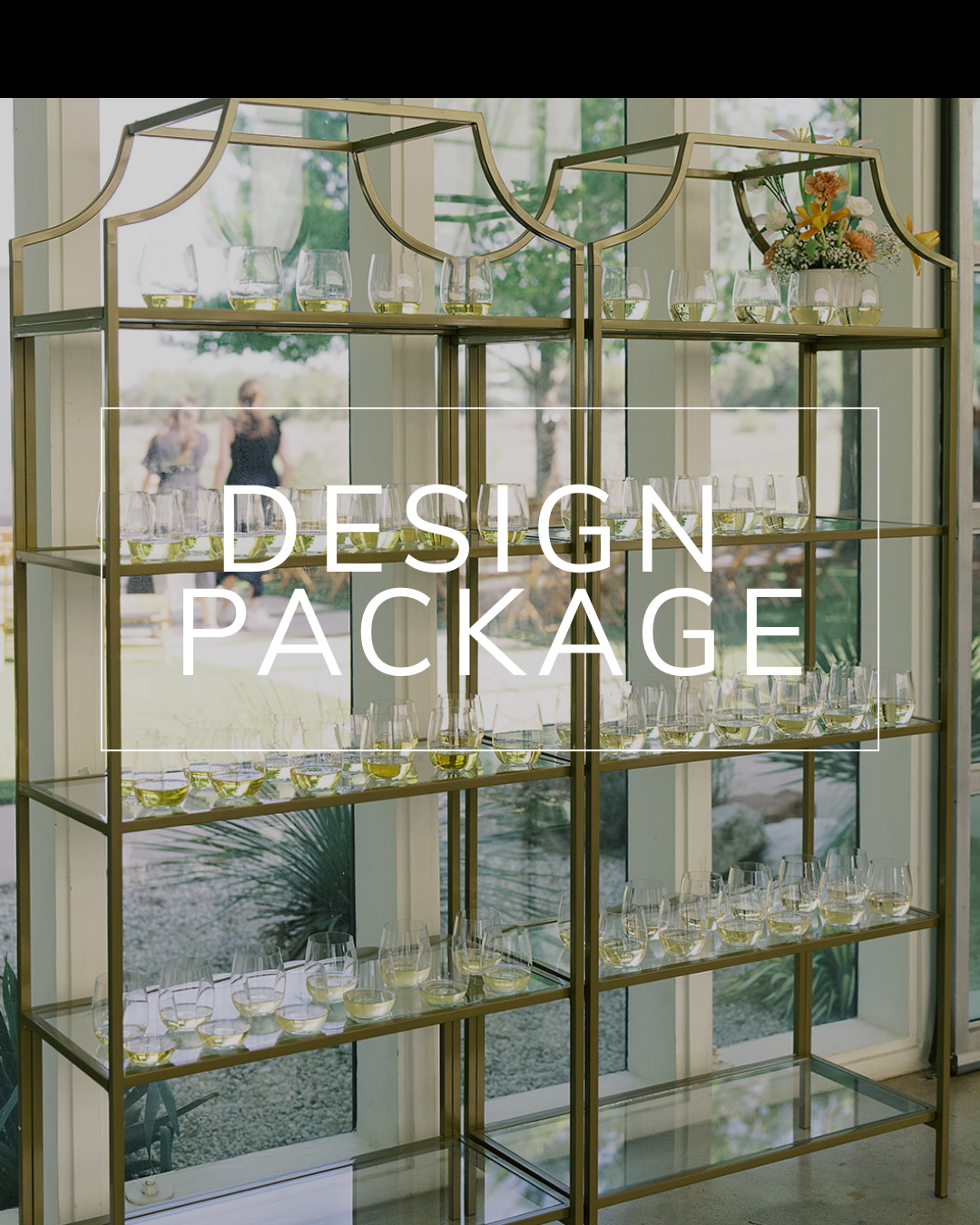 Two tall, gold-framed metal shelves with glass tiers stand before a window, featuring the text