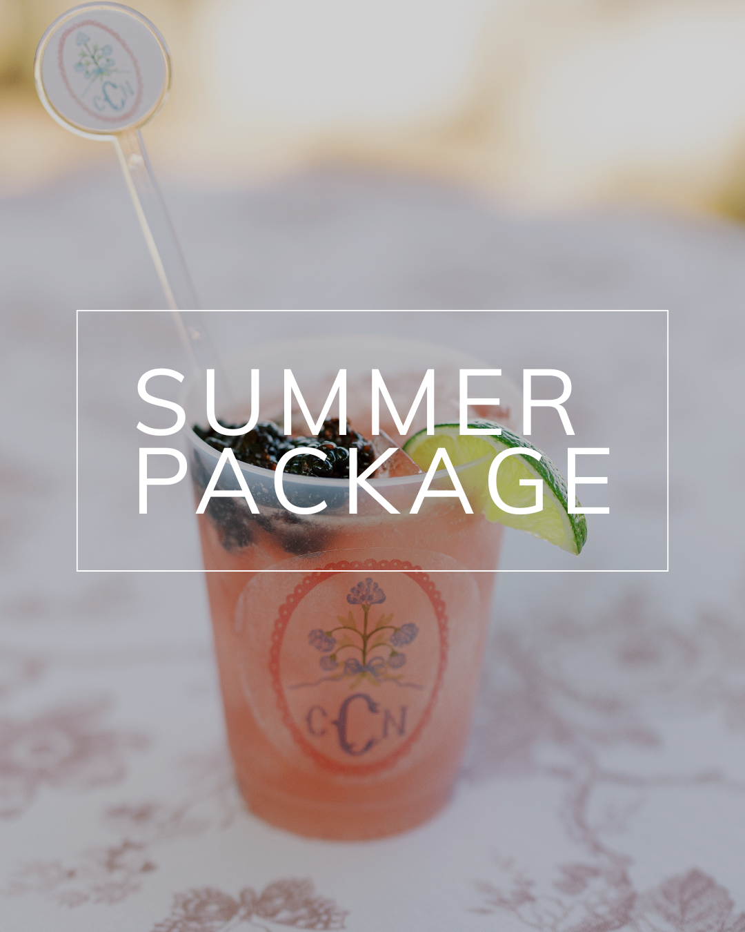A cocktail in a logo-branded plastic cup with a lime garnish and stirrer, overlaid with the text