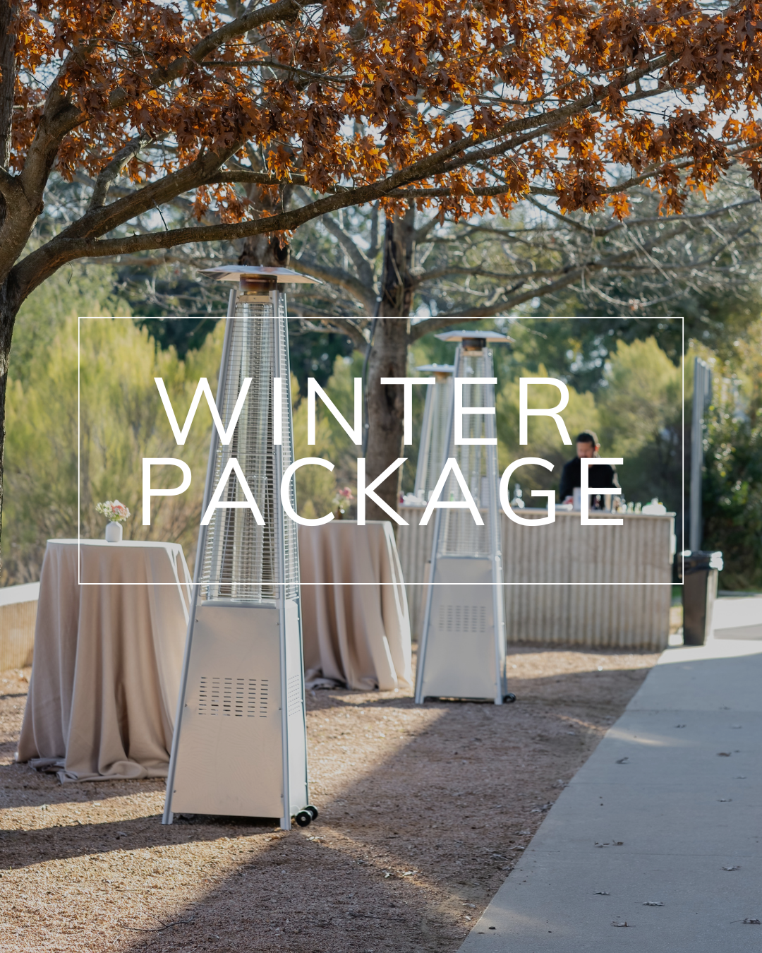 Outdoor area with patio heaters and draped cocktail tables under trees, featuring the text