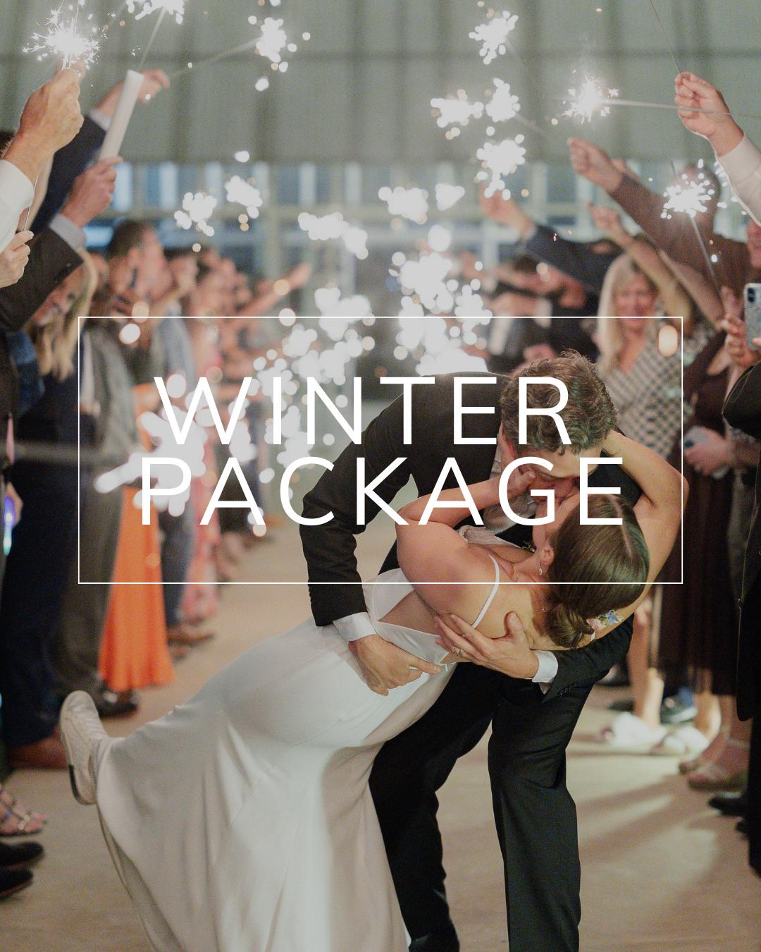 A couple kisses in a dip while surrounded by wedding guests holding sparklers under the text overlay