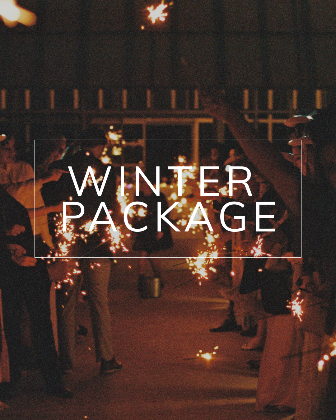 A group of people holding sparklers at night, with the text