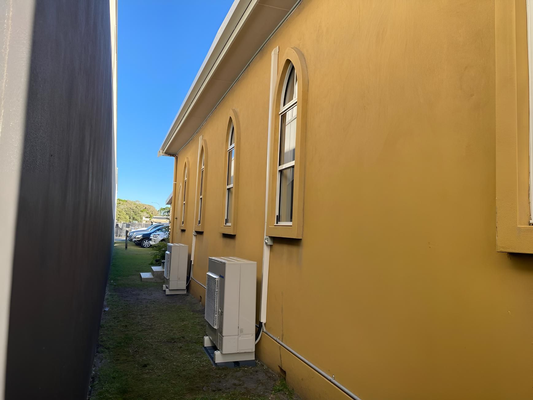 Yellow Building With a Lot of Aircon — Coolman Airconditioning in Broken Head, NSW