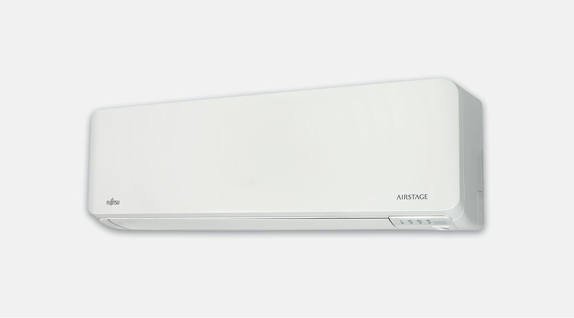 White wall-mounted air conditioner on a white wall— Coolman Airconditioning in Broken Head, NSW