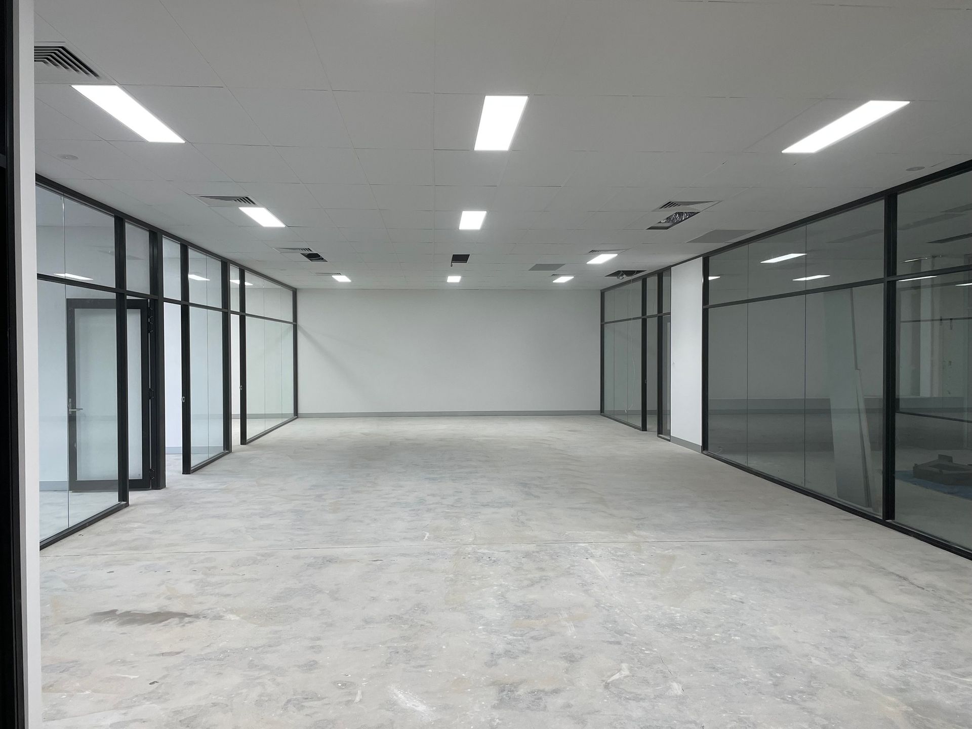 Empty Office Space with Glass-Walled Rooms — Completely Plastered North Coast in Lismore, NSW