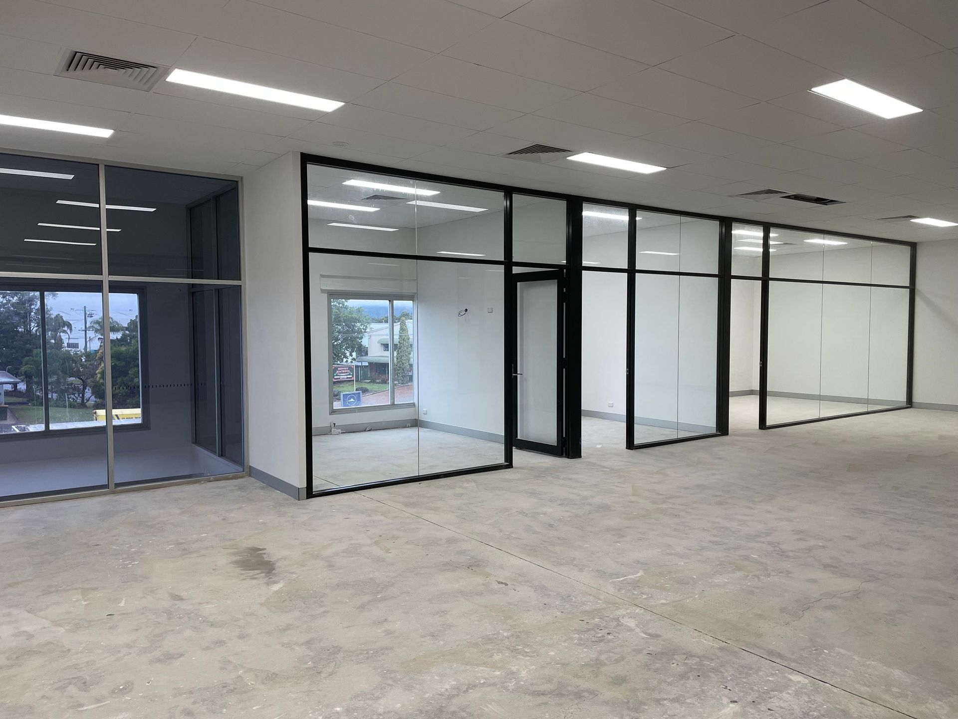 Empty Office Space with Glass and Black Metal Partitions — Completely Plastered North Coast in Byron Bay, NSW