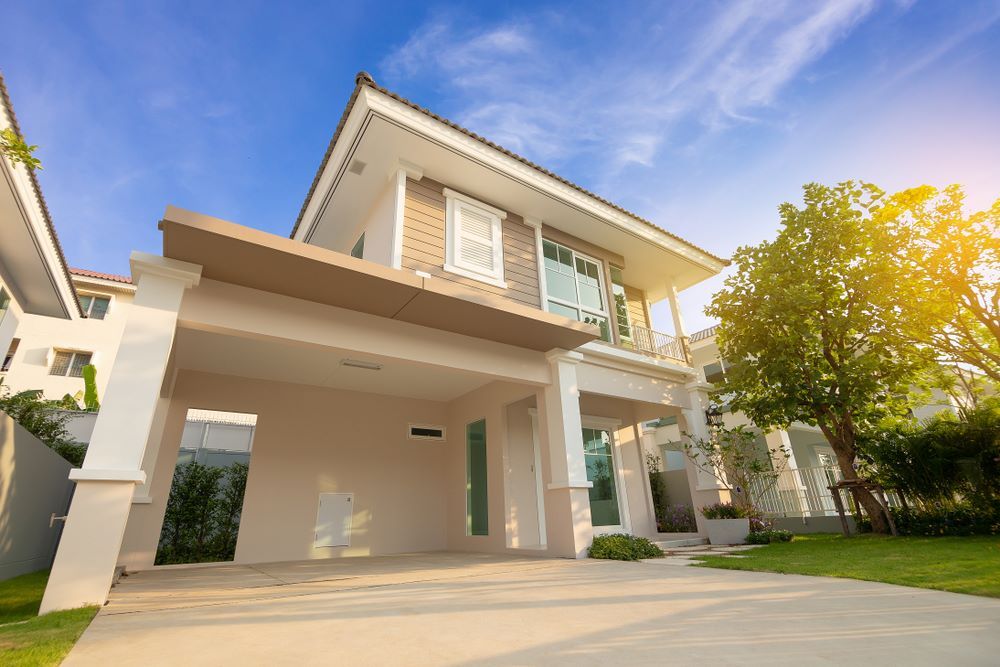 A Large House With a Garage and a Driveway in Front of It — Pro-Jax Pty Ltd in Bowen, QLD