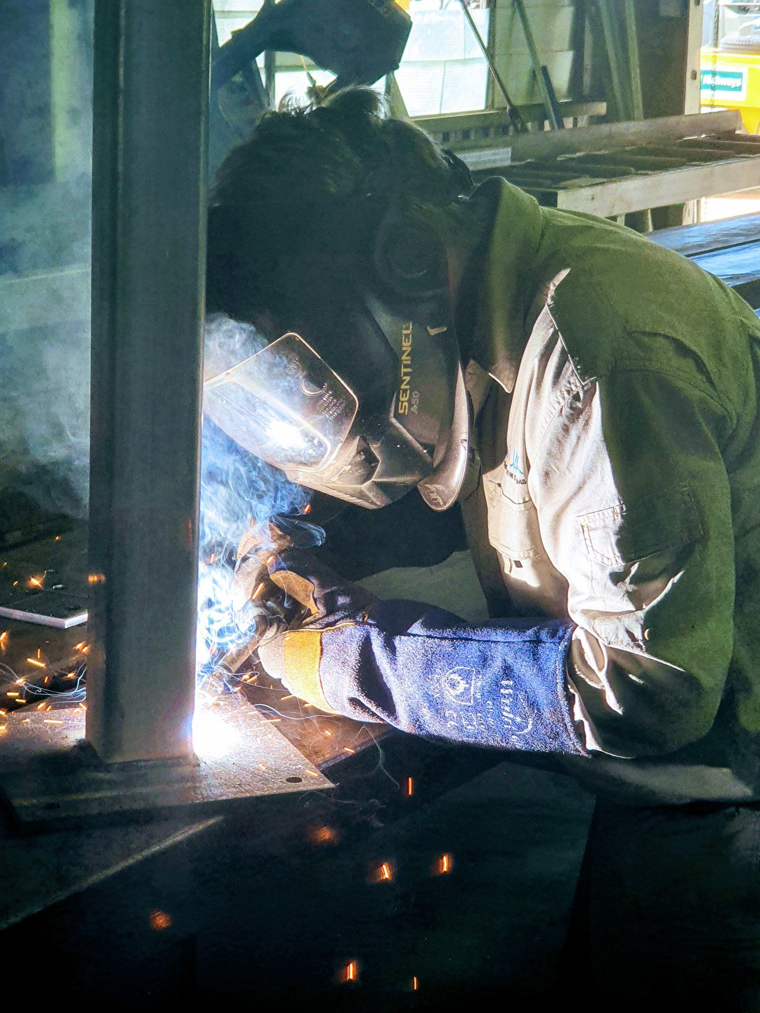 Welder in Protective Gear Welding Metal, Sparks Flying — Pro-Jax Pty Ltd in Bohle, QLD