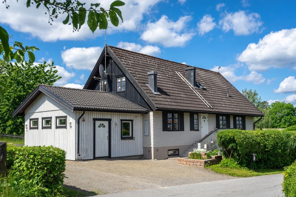 A White House With a Brown Roof and a Garage — Pro-Jax Pty Ltd in Bowen, QLD