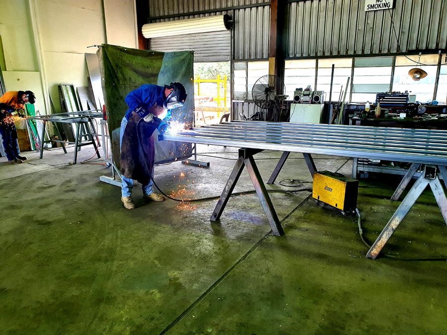 A Man is Welding a Piece of Metal in a Factory  — Pro-Jax Pty Ltd in Emerald, QLD