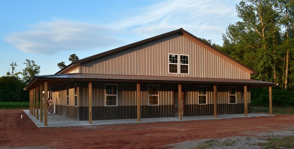A Large Barn With a Porch and a Lot of Windows — Pro-Jax Pty Ltd in Bowen, QLD