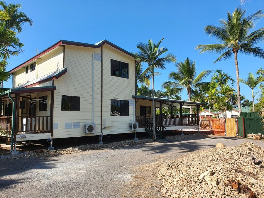 A White House With a Porch and Palm Trees in the Background — Pro-Jax Pty Ltd in Mackay, QLD