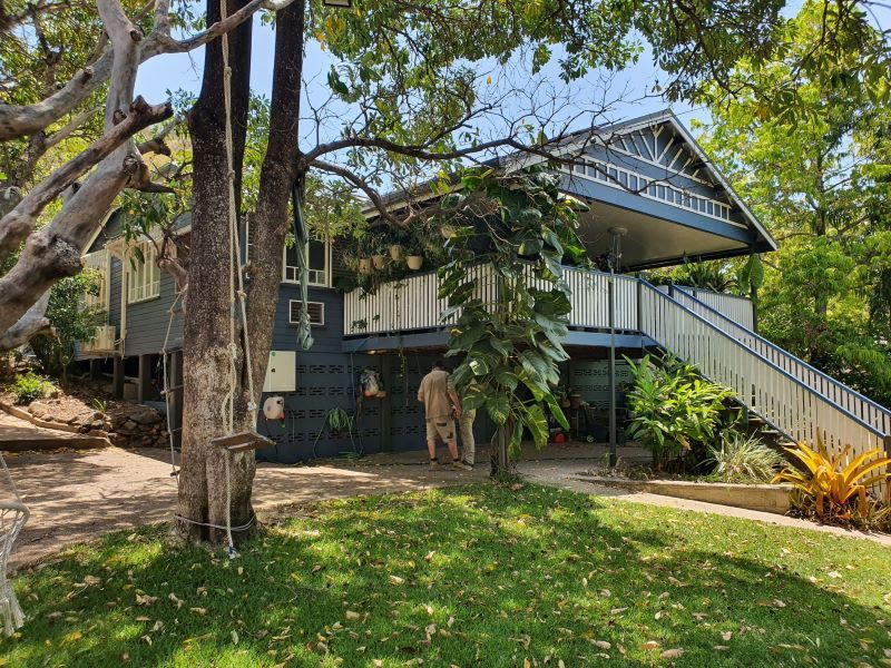 A Giraffe is Standing in Front of a House With Stairs — Pro-Jax Pty Ltd in Ingham, QLD