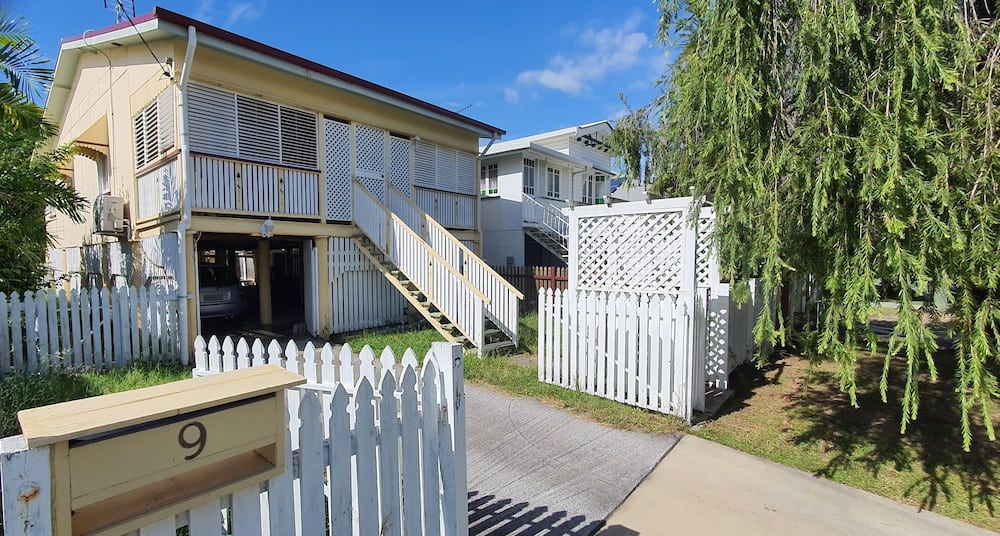Yellow House With White Picket Fence, Stairs Leading to the Balcony — Pro-Jax Pty Ltd in Hughenden, QLD