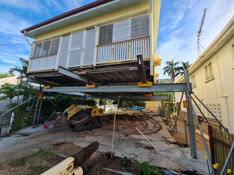 A House is Being Lifted Into Place by a Bulldozer  — Pro-Jax Pty Ltd in Bohle, QLD