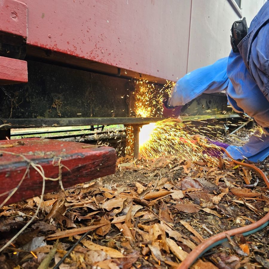 A Person is Cutting a Piece of Metal With Sparks Coming Out of It — Pro-Jax Pty Ltd in Ayr, QLD