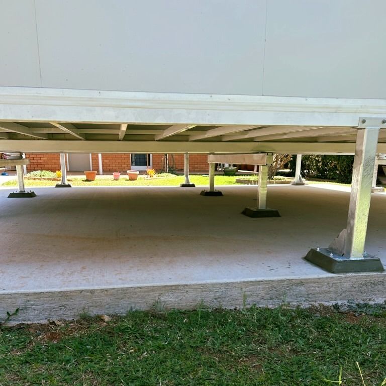 The Underside of a Building With a Brick Building in the Background — Pro-Jax Pty Ltd in Ingham, QLD