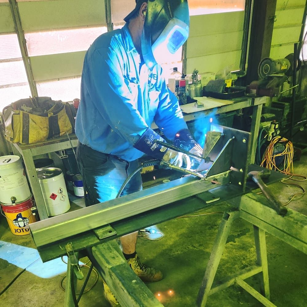 A Welders Working on Metal Frames in a Workshop — Pro-Jax Pty Ltd in Bowen, QLD