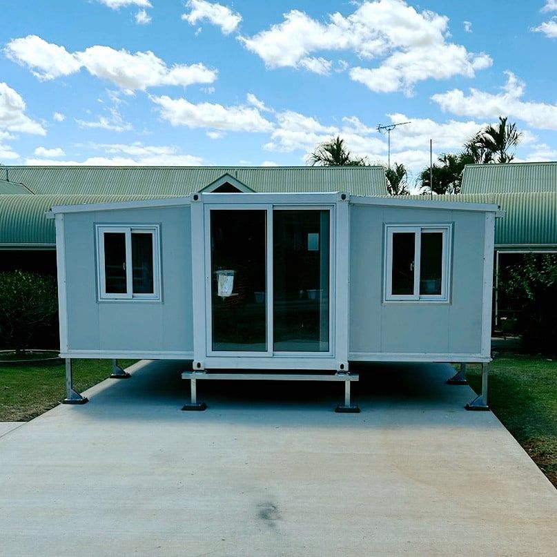 Modular Gray Cabin With Sliding Glass Door, White Windows, and Green Roof — Pro-Jax Pty Ltd in Hughenden, QLD