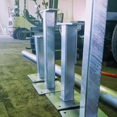 Four Square Metal Posts With Base Plates, in a Warehouse — Pro-Jax Pty Ltd in Bohle, QLD