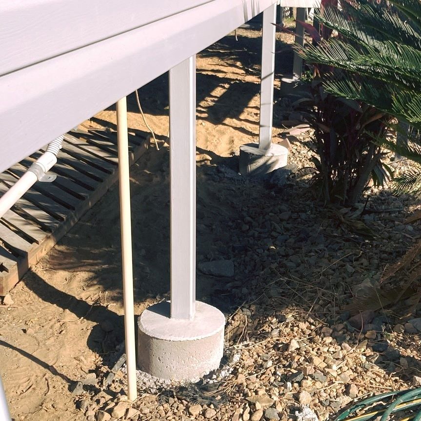 A Concrete Pillar in the Dirt Under a Deck  — Pro-Jax Pty Ltd in Bohle, QLD