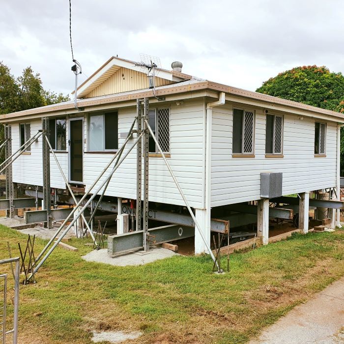 A White House is Sitting on Stilts in the Grass — Pro-Jax Pty Ltd in Bohle, QLD