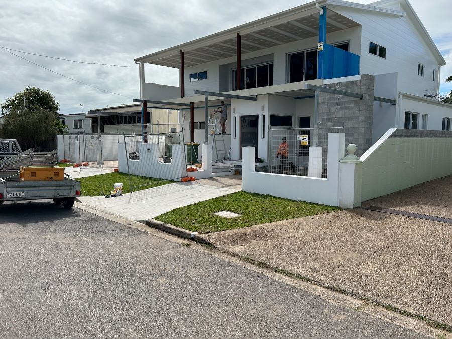 A Large White House With a Blue Balcony is Being Built — Pro-Jax Pty Ltd in Mackay, QLD