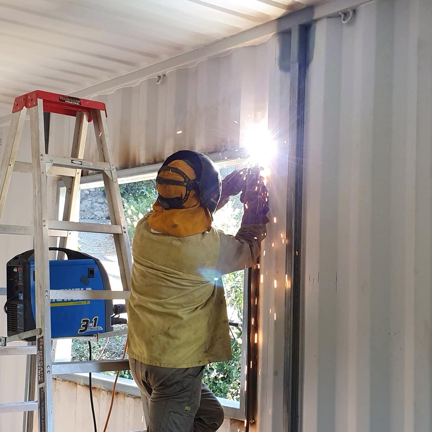 A Man is Standing on a Ladder Welding a Piece of Metal  — Pro-Jax Pty Ltd in Emerald, QLD
