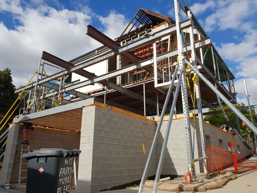 A Building Under Construction With a Trash Can in Front of It — Pro-Jax Pty Ltd in Bohle, QLD