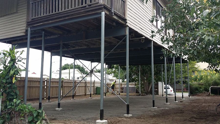 A House is Sitting on Stilts With a Fence in the Background  — Pro-Jax Pty Ltd in Bohle, QLD