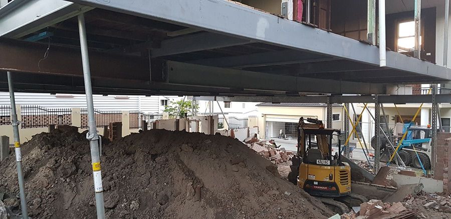 A Construction Site With a Pile of Dirt and a Bulldozer — Pro-Jax Pty Ltd in Mount Isa, QLD