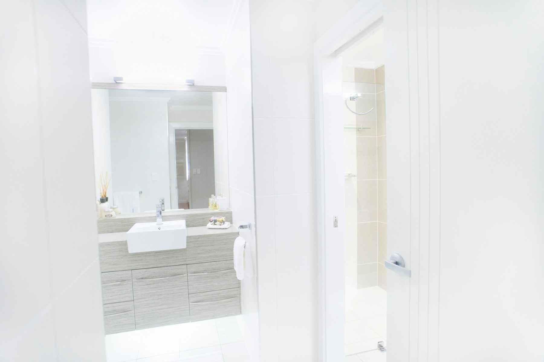 A Bathroom With a Sink, Mirror and Shower — Pro-Jax Pty Ltd in Bohle, QLD