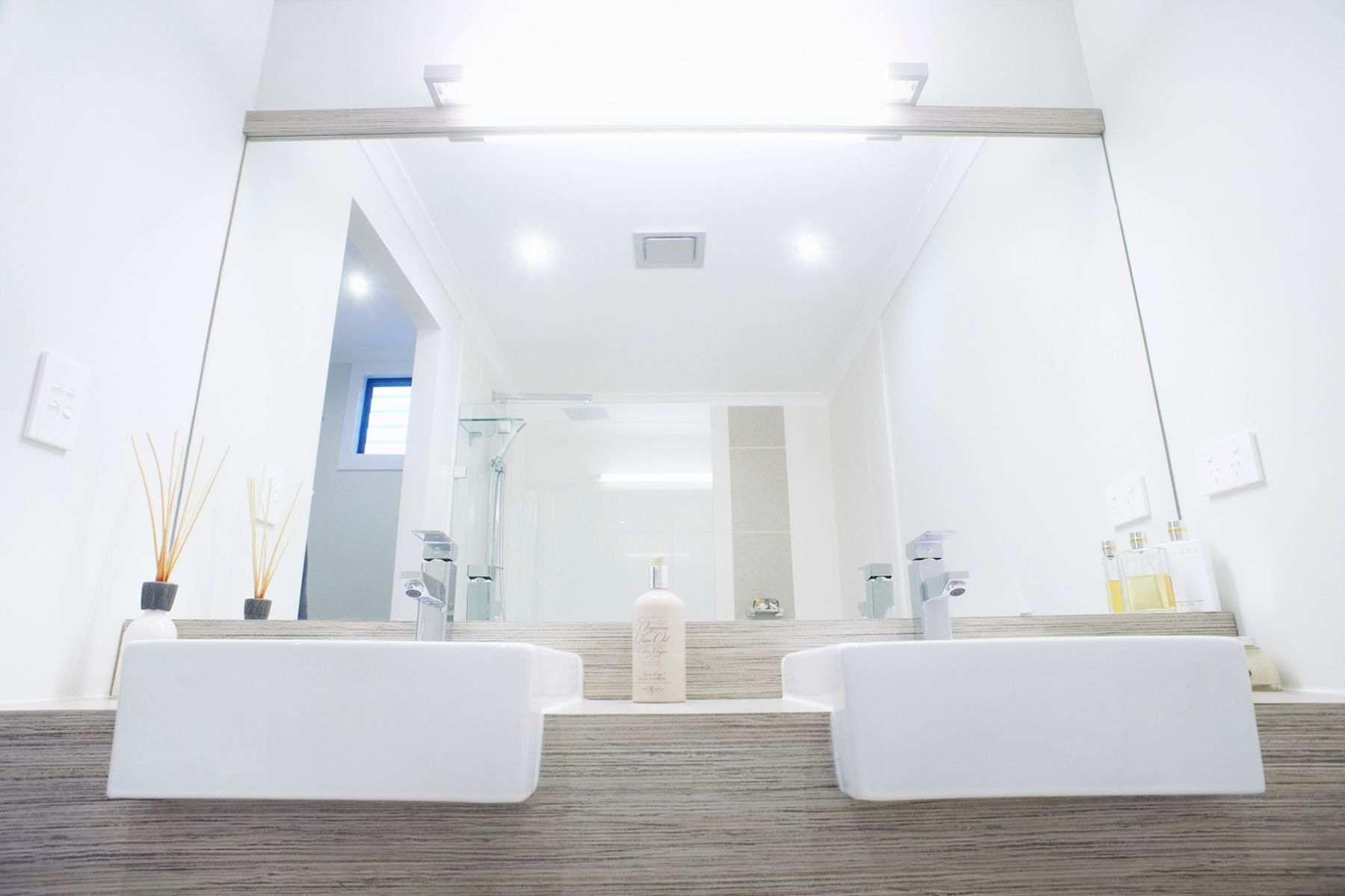 A Bathroom With Two Sinks and a Large Mirror — Pro-Jax Pty Ltd in Bohle, QLD