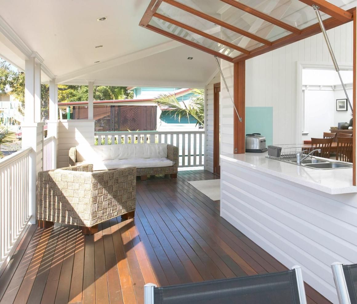 A Living Room With a Couch and Chairs and a Kitchen — Pro-Jax Pty Ltd in Bohle, QLD