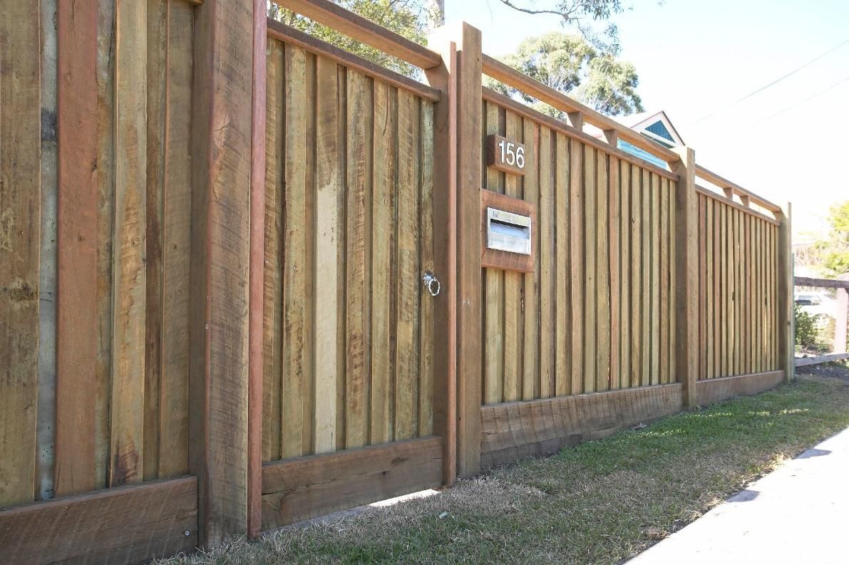 A Wooden Fence With a Mailbox in the Middle of It — Pro-Jax Pty Ltd in Bohle, QLD