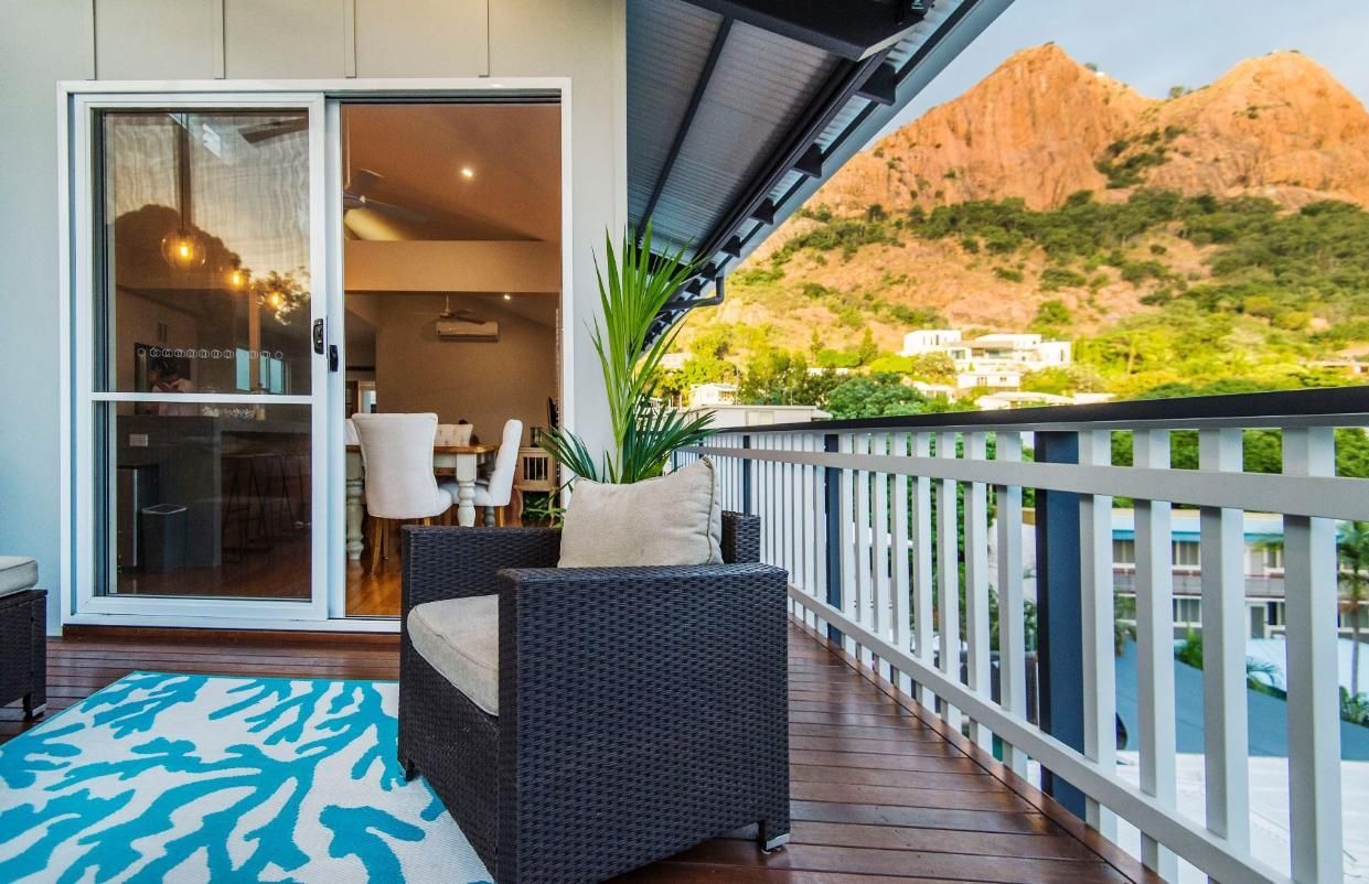 A Balcony With a Couch and a Chair and a Mountain in the Background — Pro-Jax Pty Ltd in Bohle, QLD
