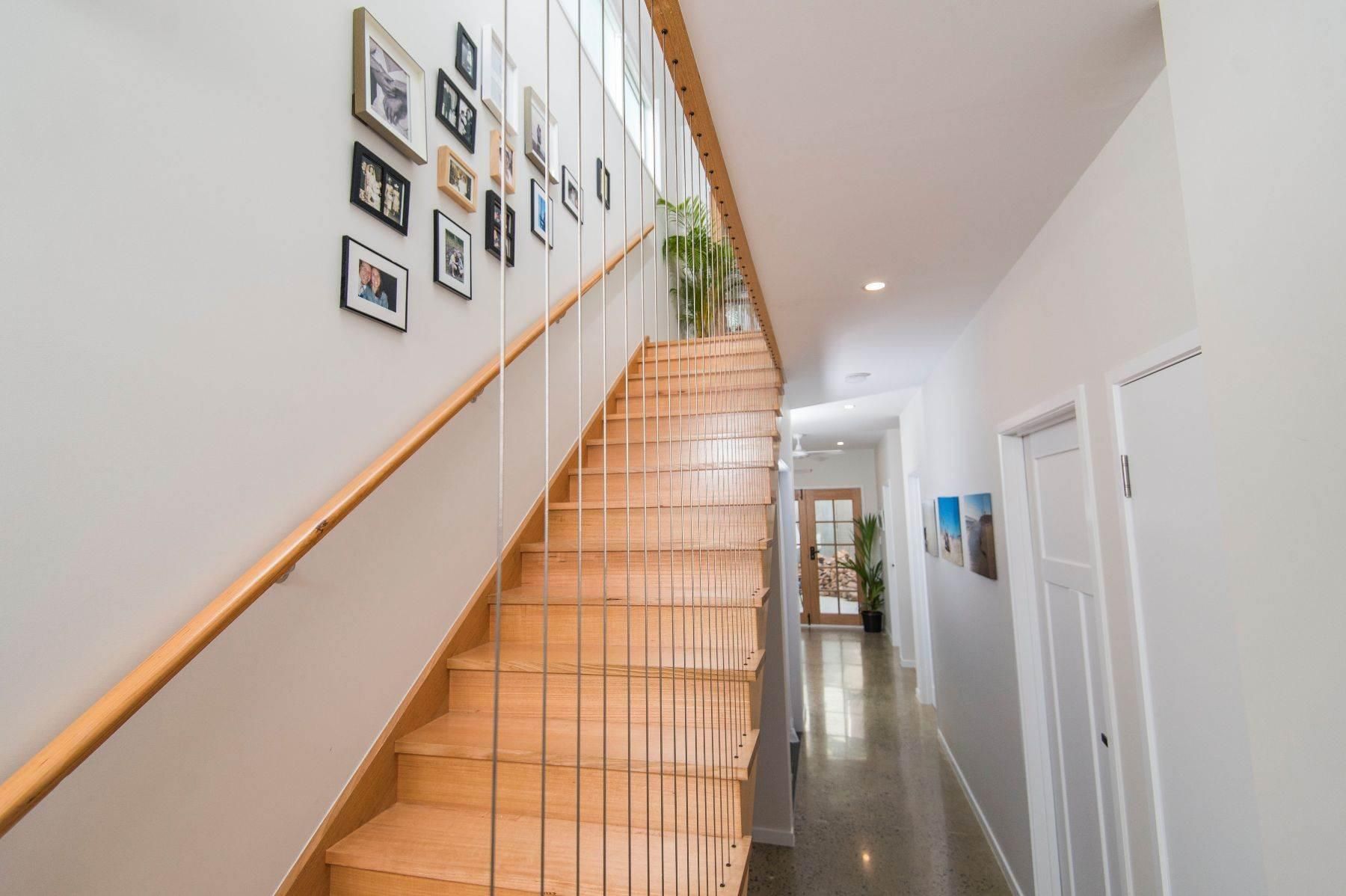 A Wooden Staircase Leading Up to the Second Floor of a House — Pro-Jax Pty Ltd in Bohle, QLD