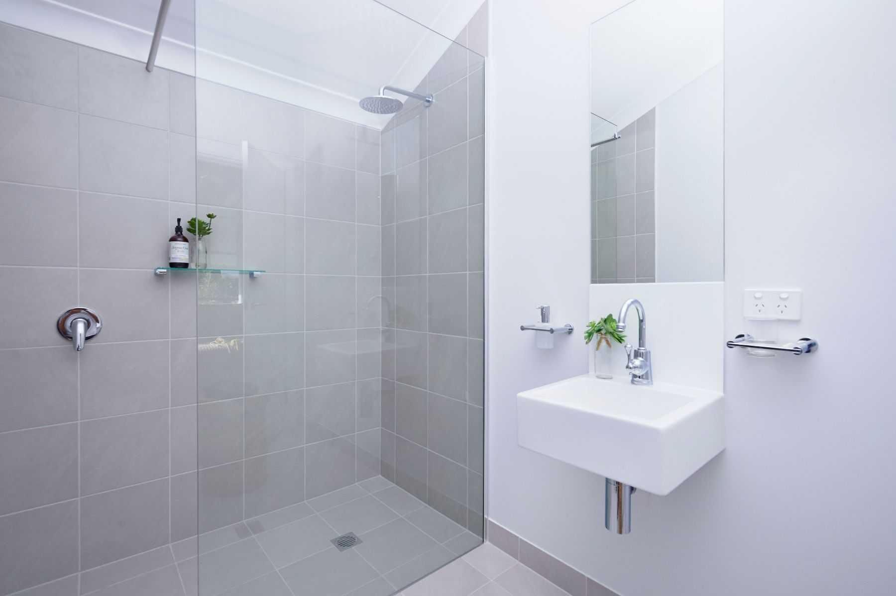 A Bathroom With a Walk in Shower, Sink and Mirror — Pro-Jax Pty Ltd in Bohle, QLD