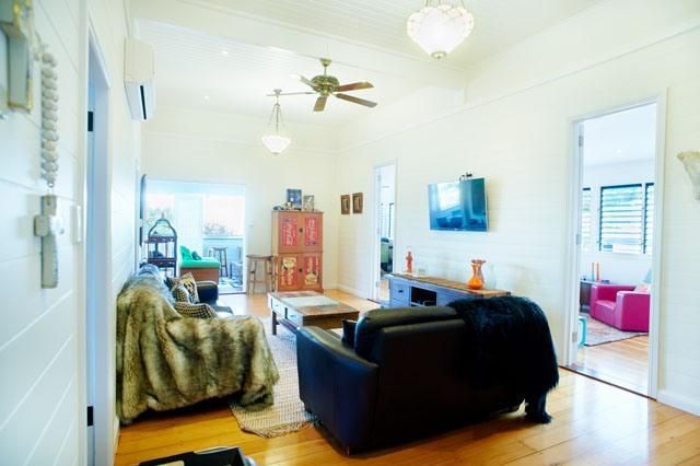 A Living Room With a Couch, Chair, Coffee Table and Ceiling Fan — Pro-Jax Pty Ltd in Bohle, QLD
