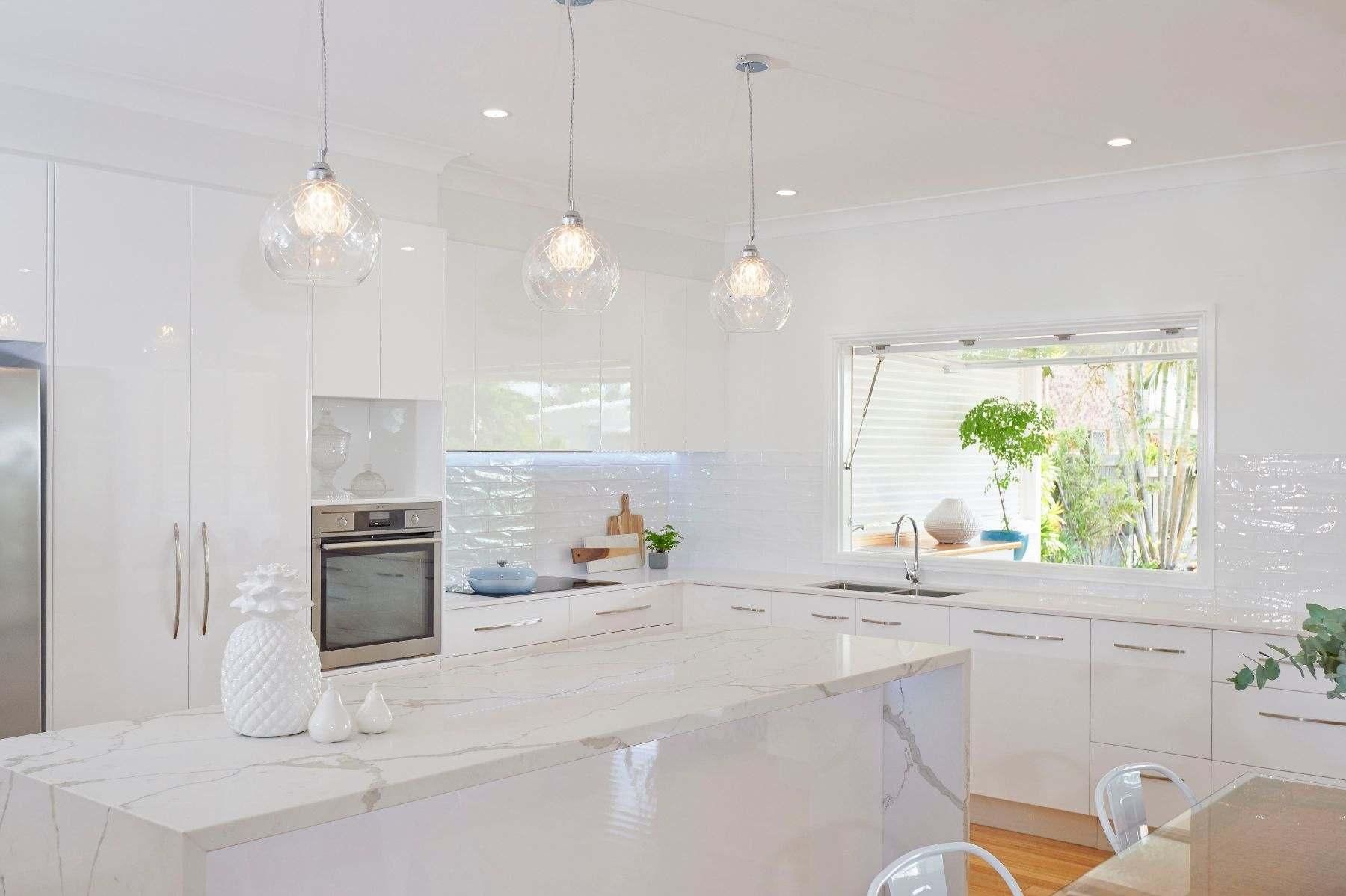A Kitchen With White Cabinets, Marble Counter Tops, Stainless Steel Appliances — Pro-Jax Pty Ltd in Bohle, QLD