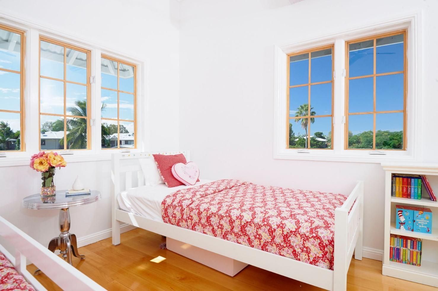 A Bedroom With Two Beds, a Table, and a Bookshelf — Pro-Jax Pty Ltd in Bohle, QLD
