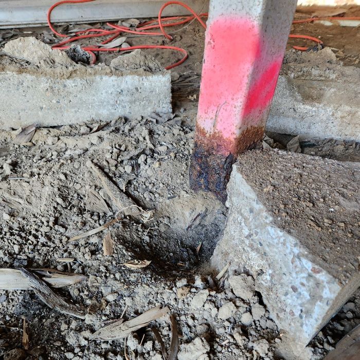 A Red Marker is Painted on a Concrete Post — Pro-Jax Pty Ltd in Bohle, QLD