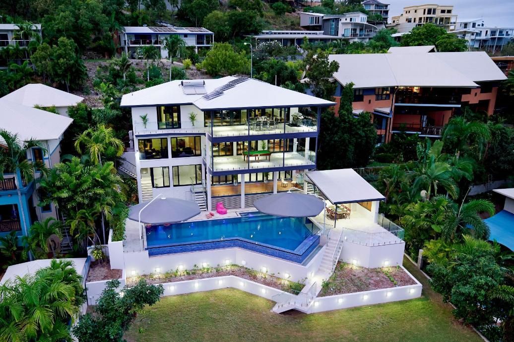 An Aerial View of a Large House With a Swimming Pool Surrounded by Trees — Pro-Jax Pty Ltd in Bohle, QLD