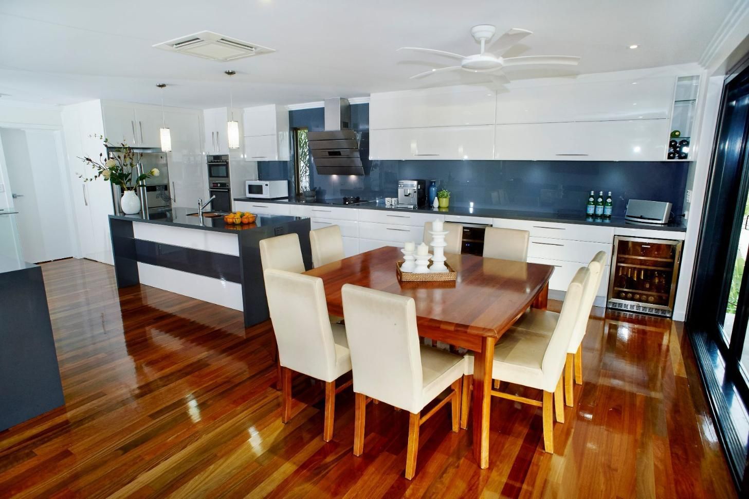 A Kitchen With a Table and Chairs and a Ceiling Fan — Pro-Jax Pty Ltd in Bohle, QLD